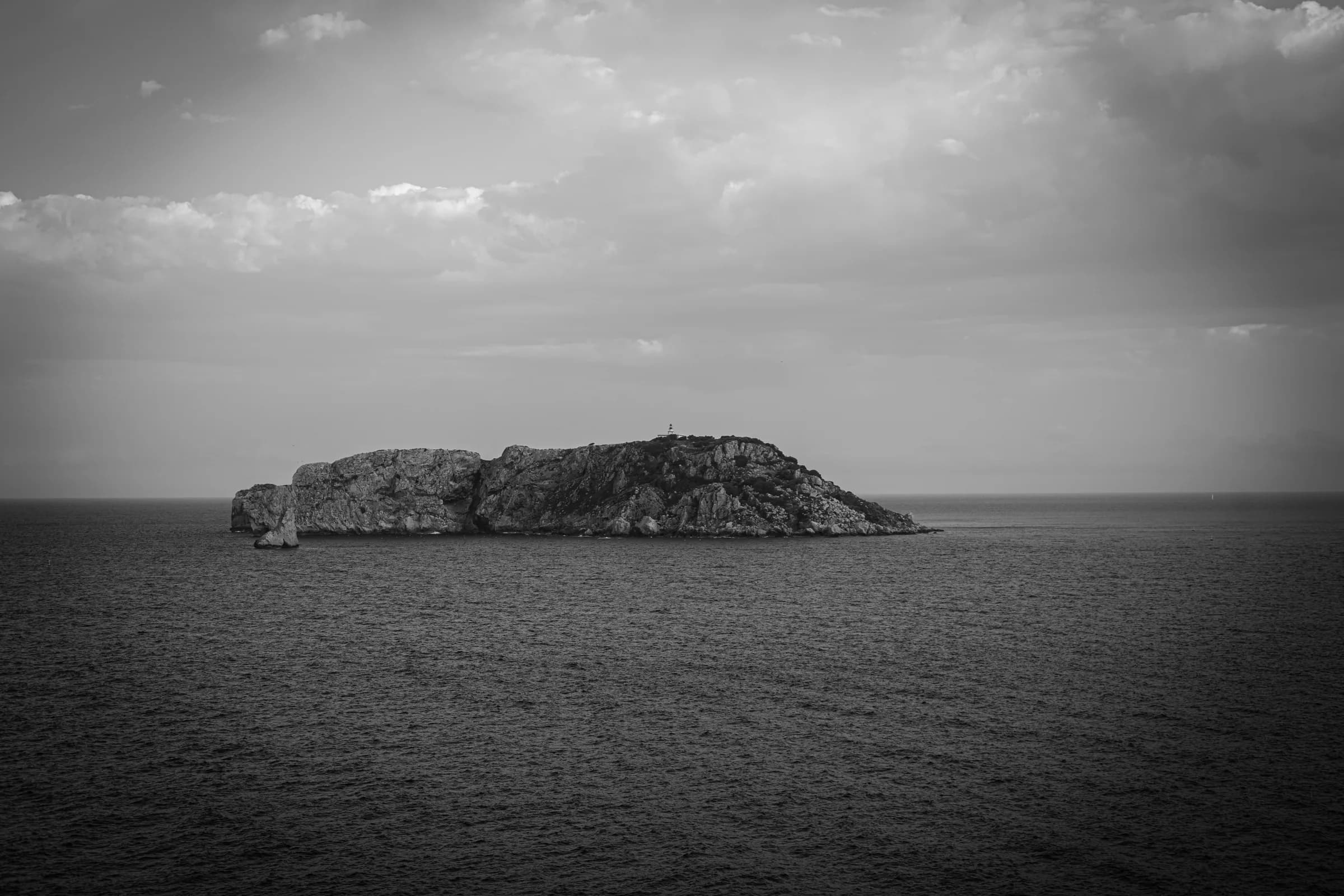 A Medes island beneath a stormy sky